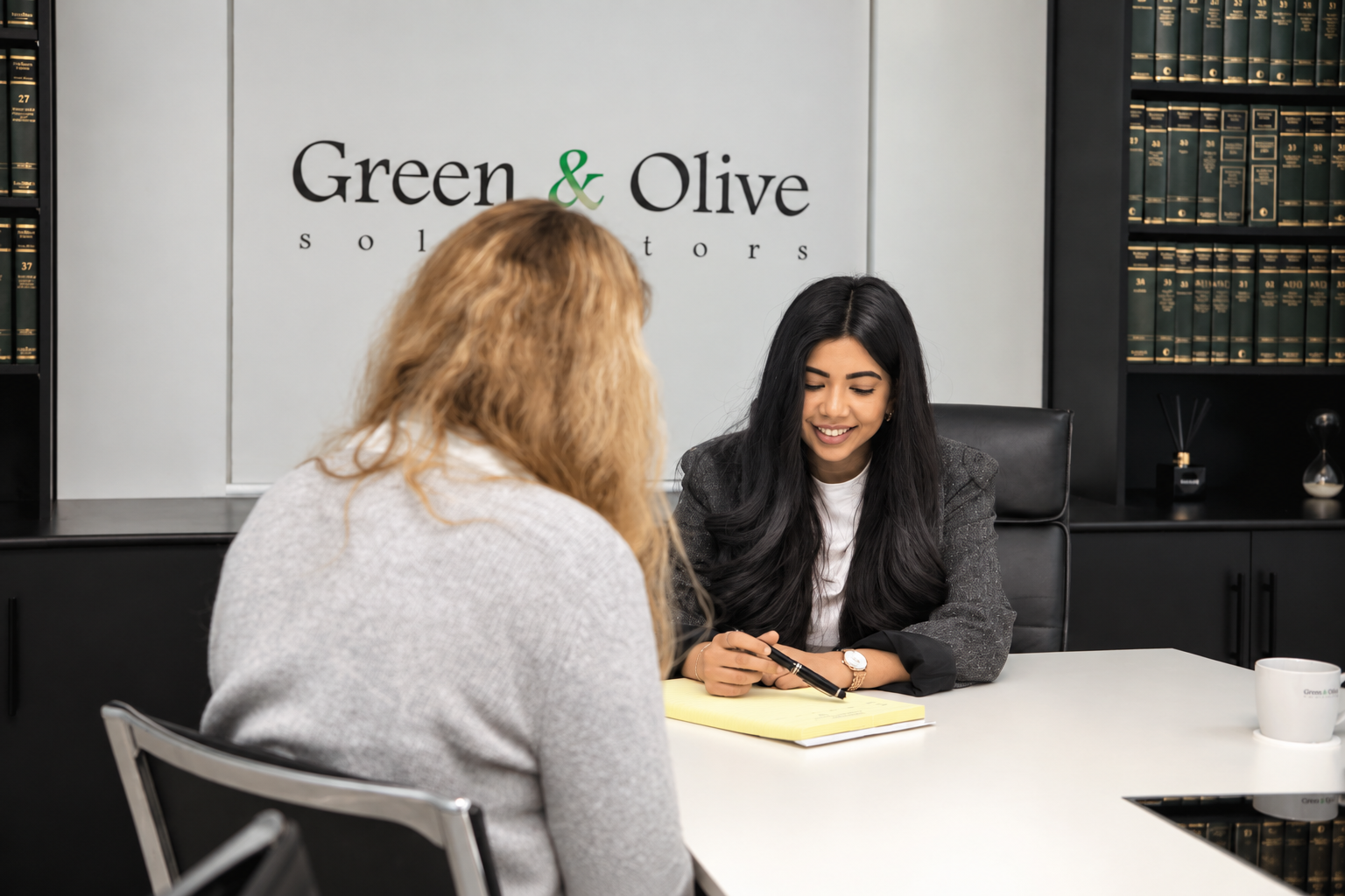 A solicitor advising a client in the Green & Olive office